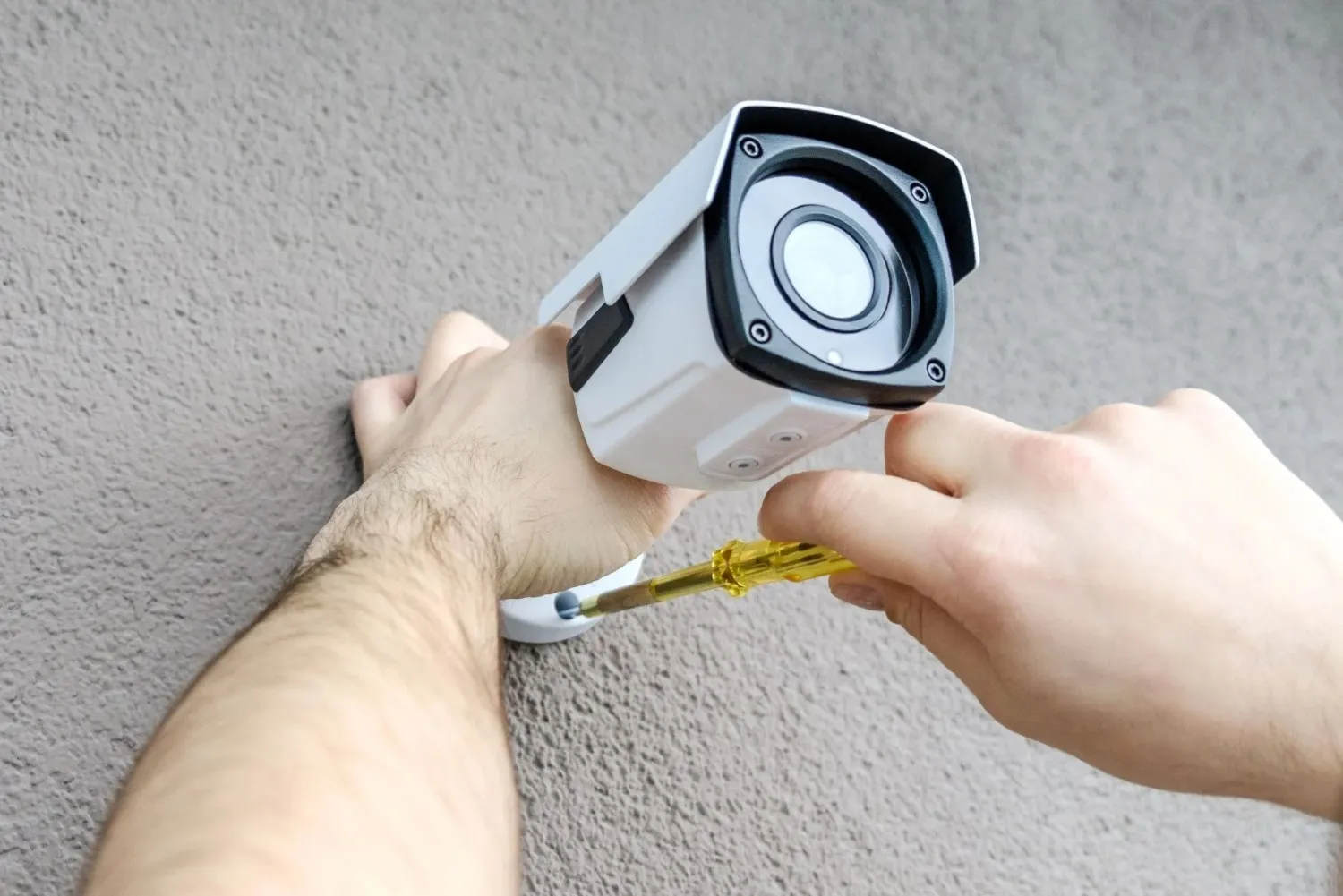 Professional technician installing an outdoor CCTV security camera
